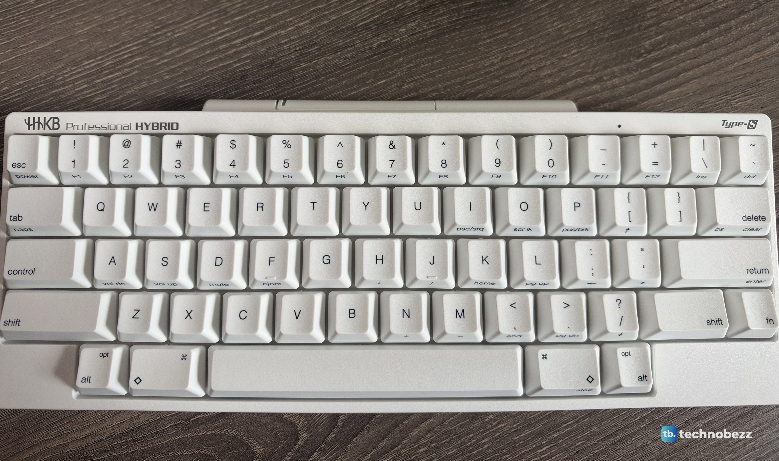 HHKB Professional HYBRID Type-S Snow with printed keycaps, top-down on a wooden desk