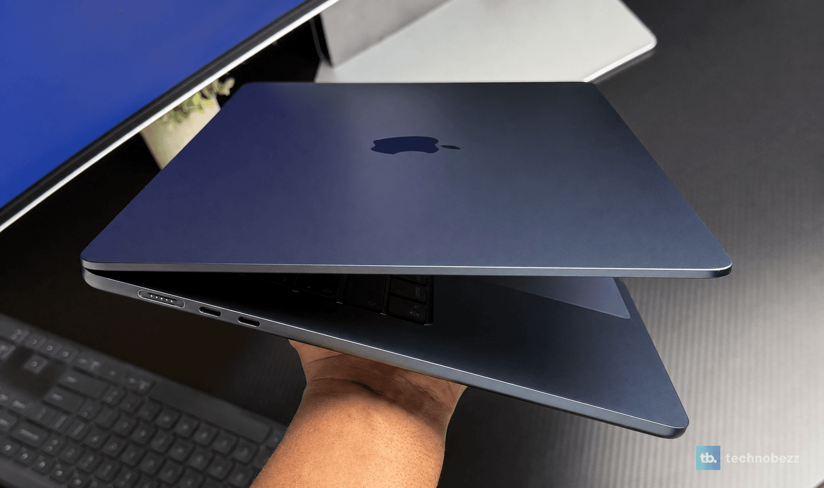 Two MacBooks held side by side showing MagSafe and Thunderbolt ports