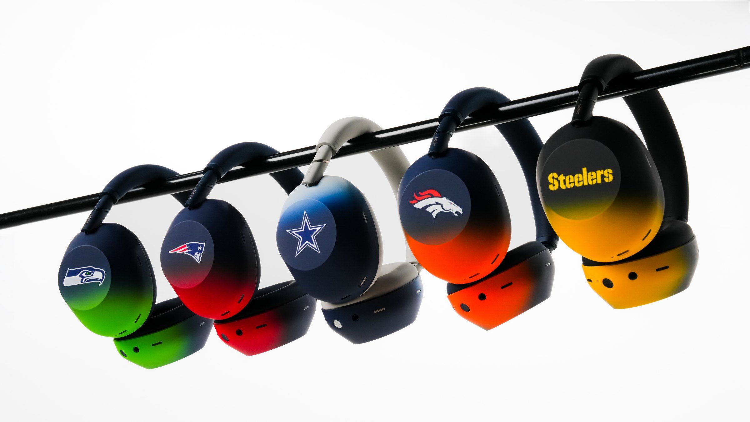 The five Sony WH-1000XM6 NFL team designs hanging from a bar