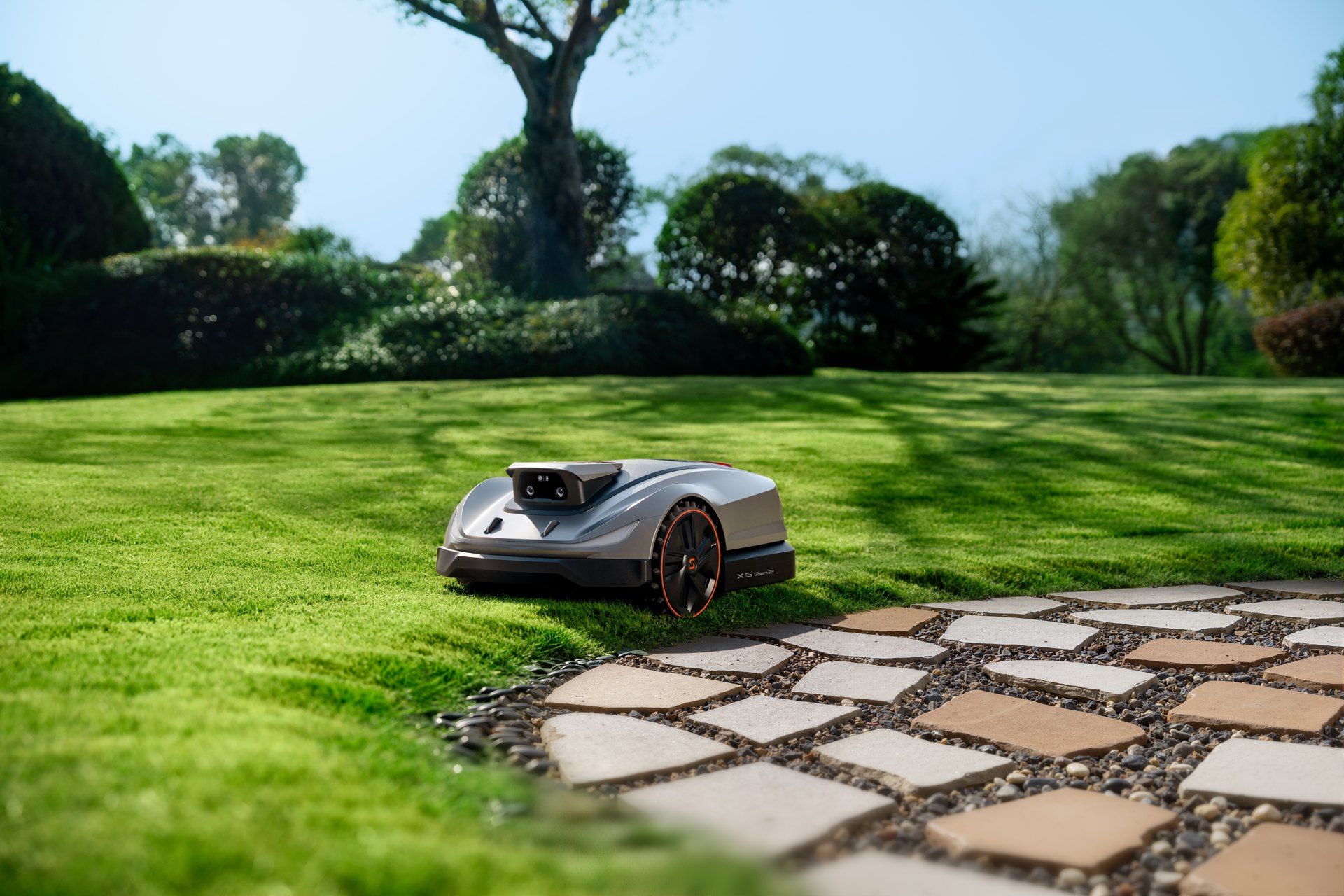 Sunseeker Elite X5 Gen 2 robot mower cutting along a stone garden path