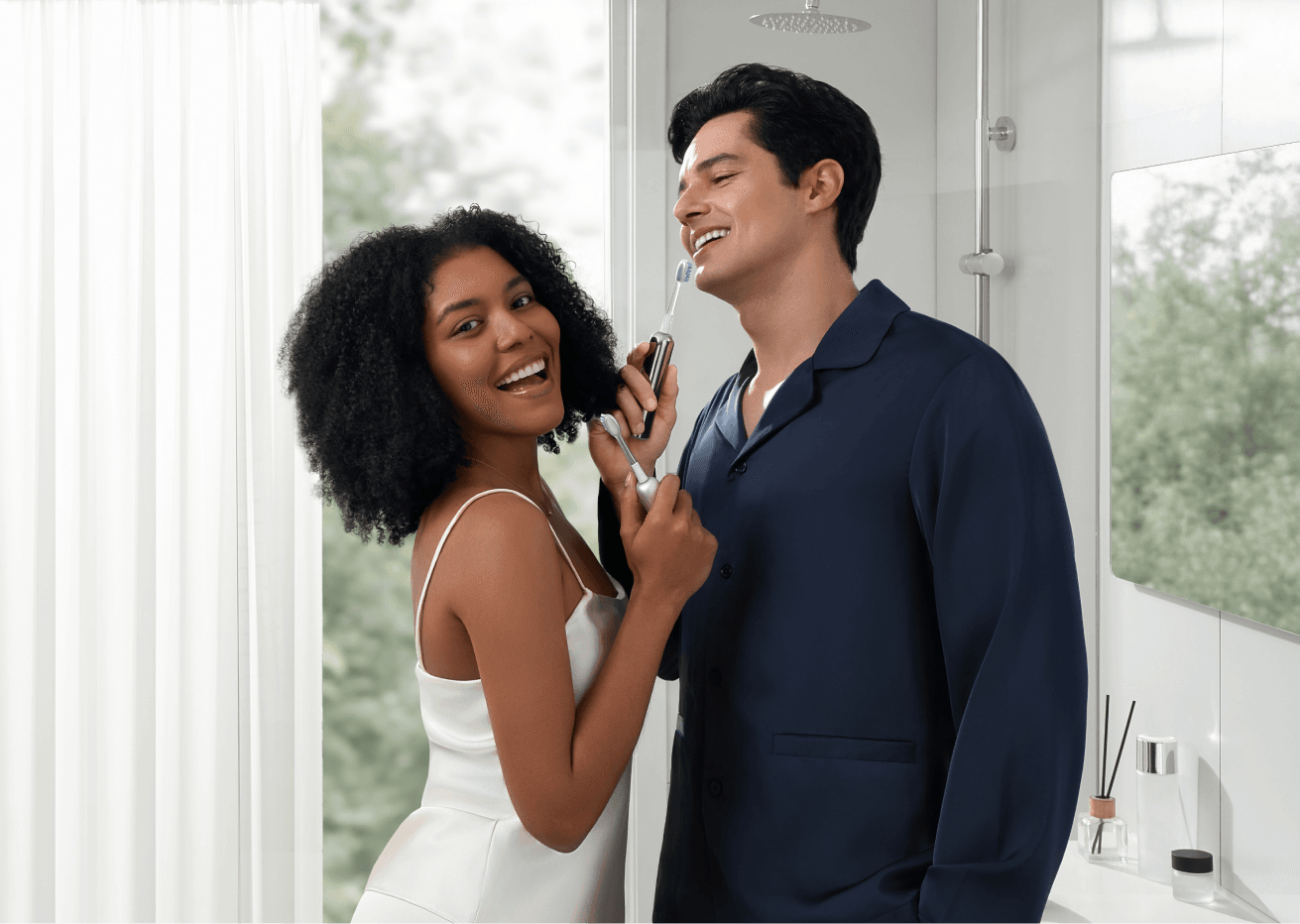 A couple in a bright bathroom, one holding the Laifen Wave Pro electric toothbrush