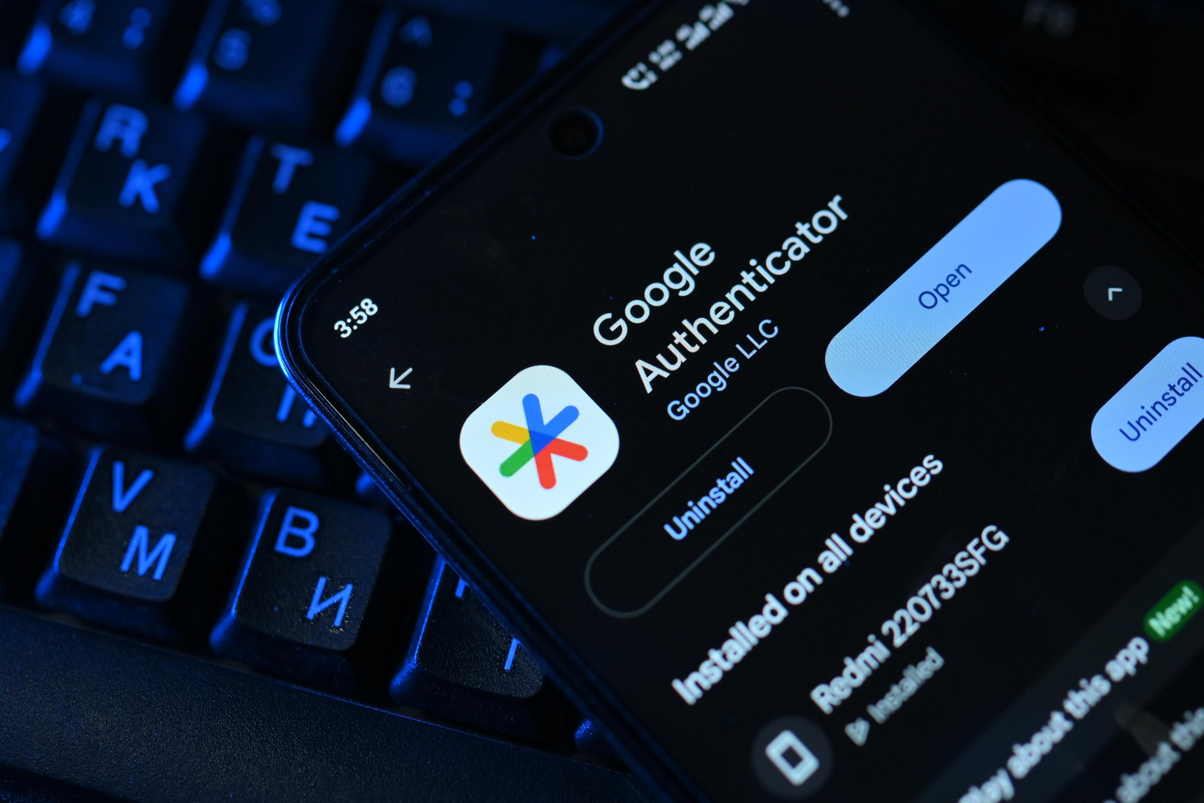 The Google Authenticator app page on an Android phone resting on a keyboard