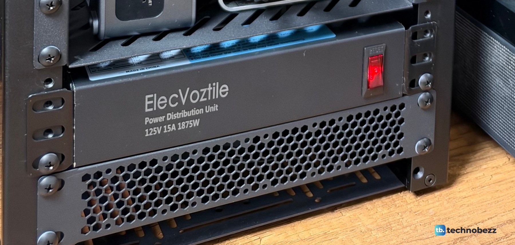 A black ElecVoztile 10-inch power distribution unit with a red power switch on the front, near the bottom of the rack