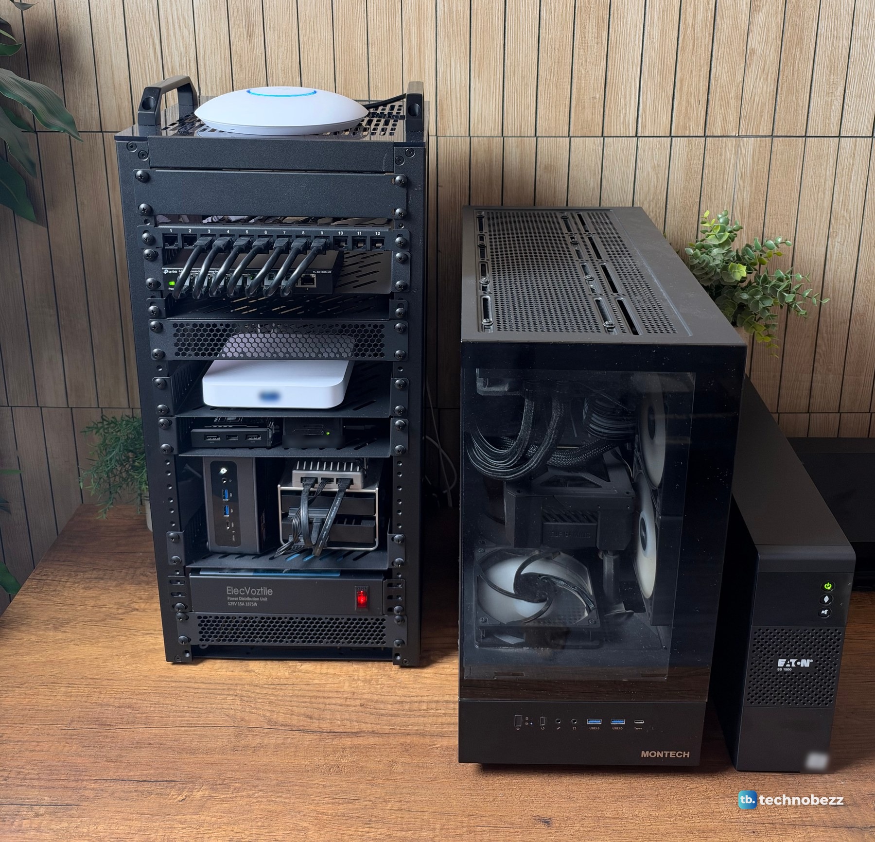 The 10-inch rack on a desk next to a black tower PC and a black Eaton UPS standing beside it