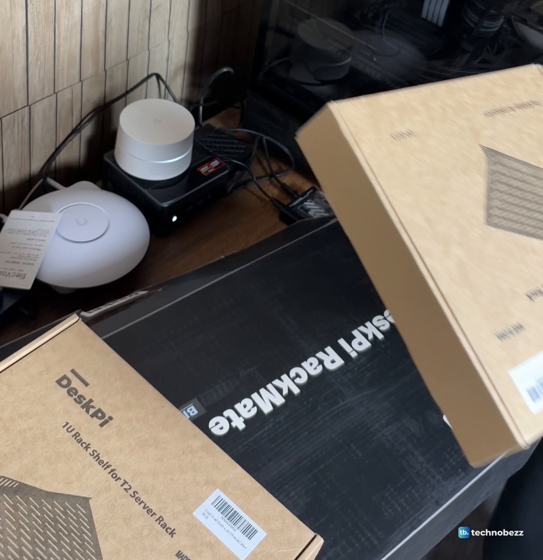 A brown DeskPi box printed 1U Rack Shelf for T2 Server Rack lying on the black DeskPi RackMate T2 box