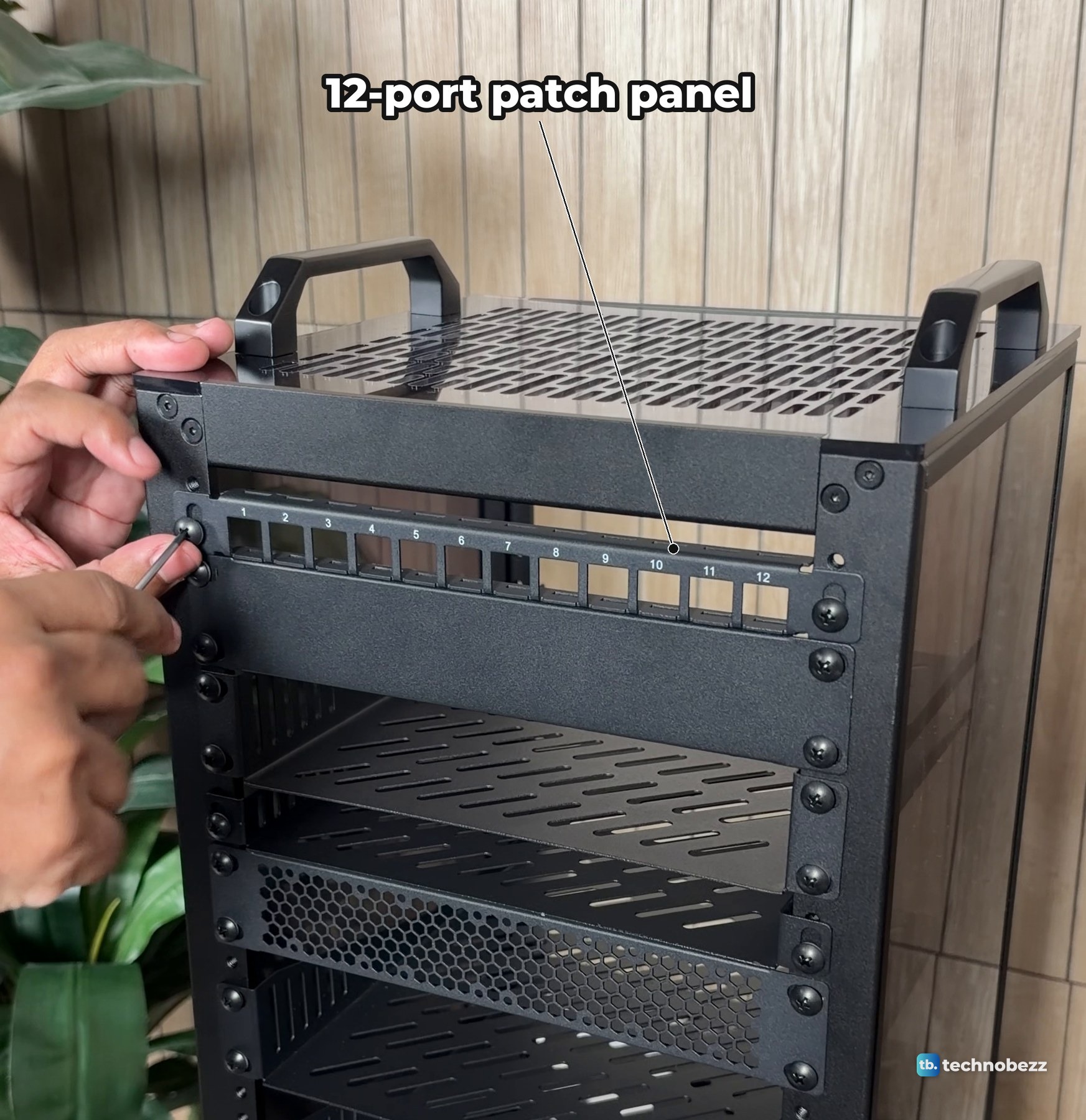The 12-port patch panel being screwed onto the front rails near the top of a DeskPi RackMate T2