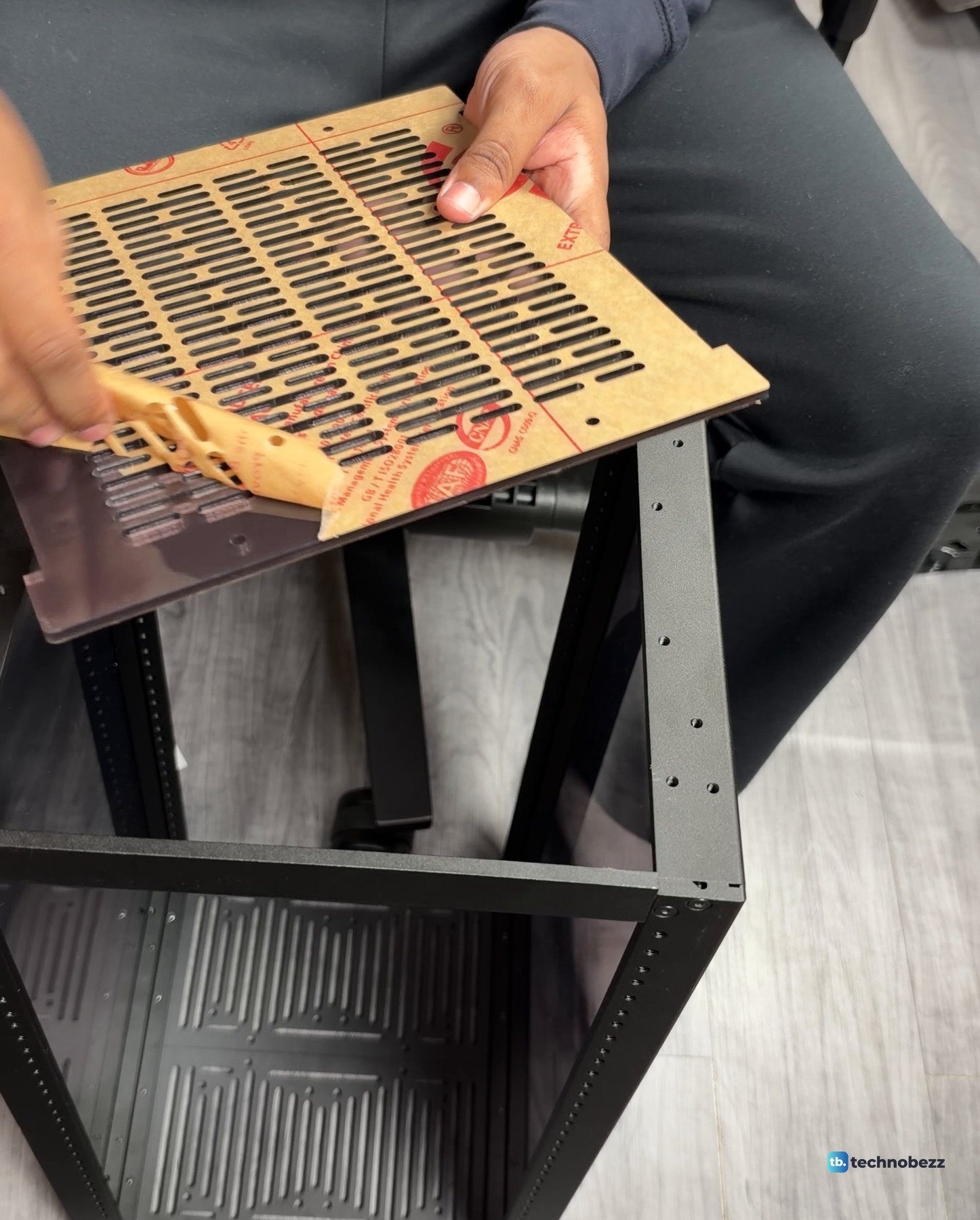 Brown protective paper peeling off the vented top plate of a DeskPi RackMate T2