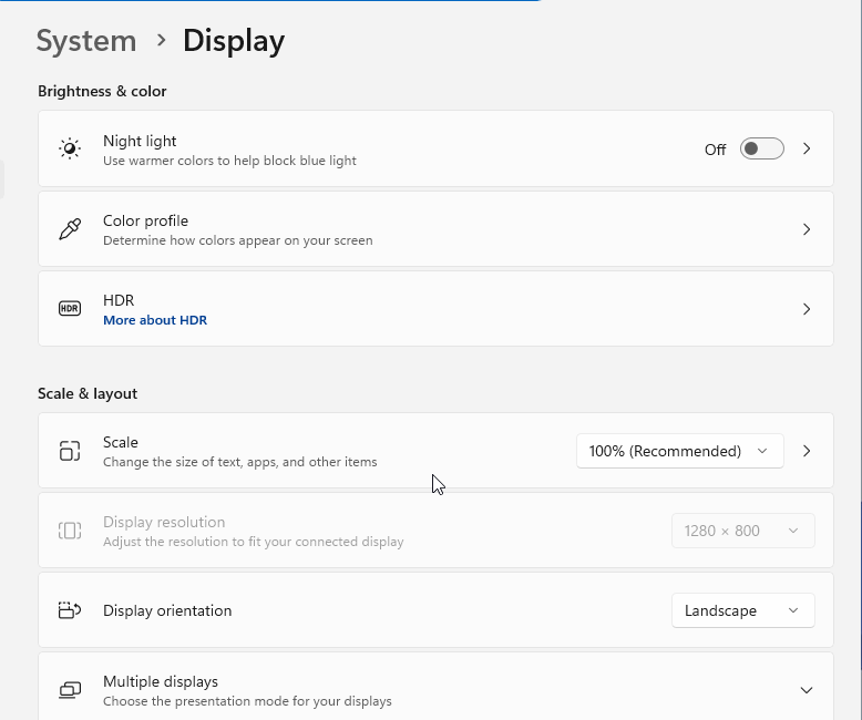 Windows 11 Display settings with Scale set to 100% (Recommended) under Scale & layout