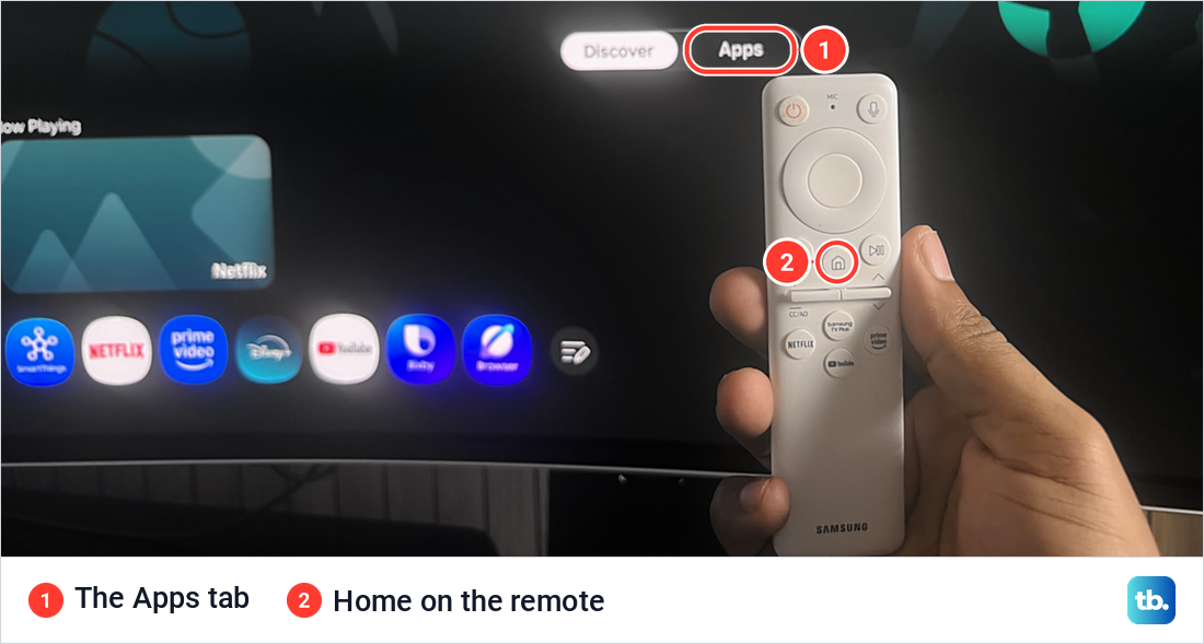 Samsung Smart Hub home screen with the Discover and Apps tabs, a row of app tiles and a white Samsung remote in a hand.