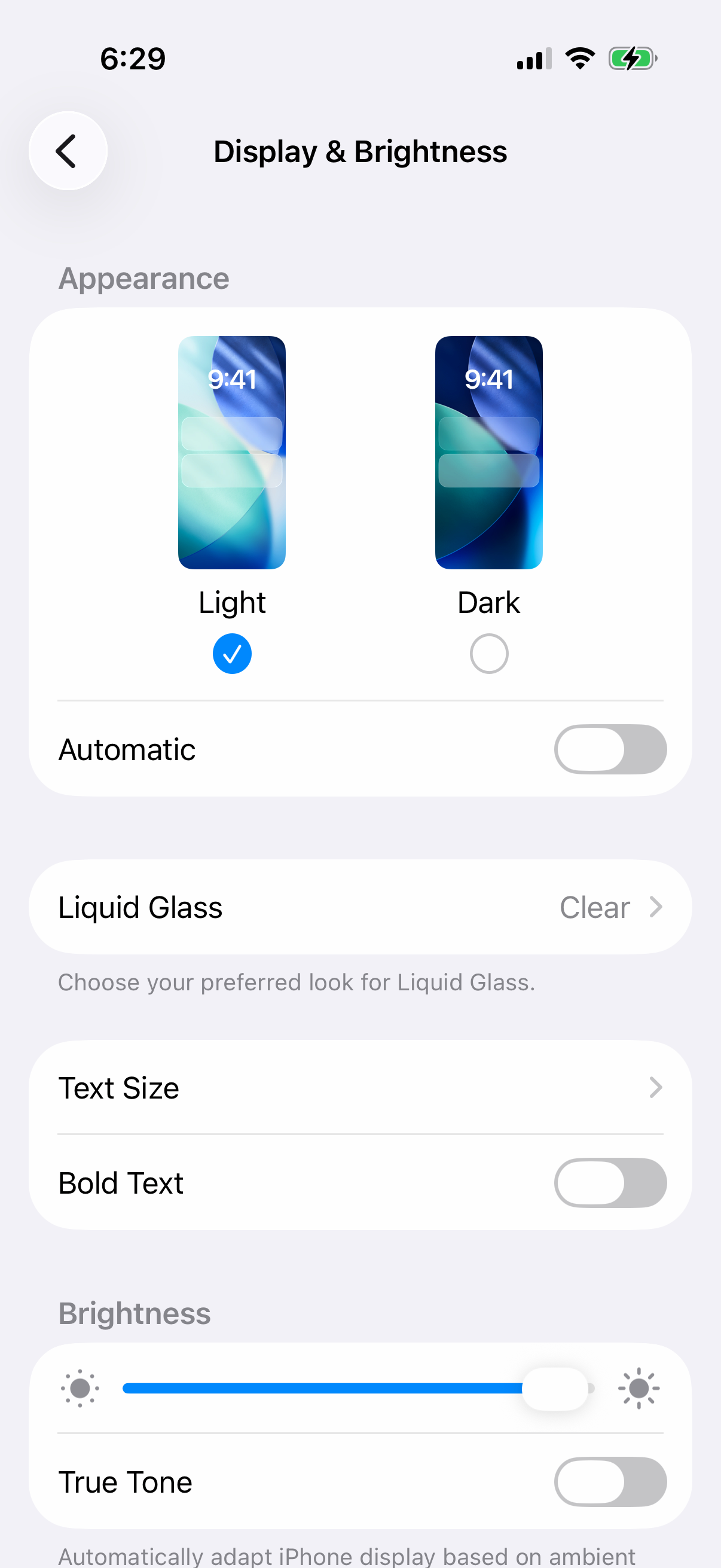 iPhone Display & Brightness settings with Light selected, Dark unselected and the Automatic switch off