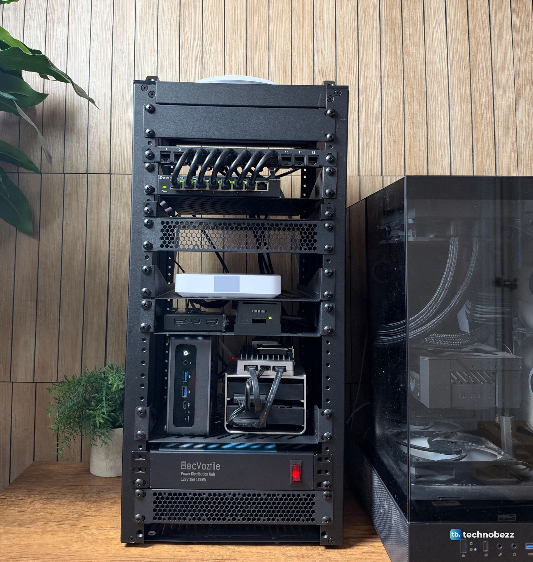 Front of a finished 10-inch home lab rack with a row of short jumpers at the top and a power strip at the bottom