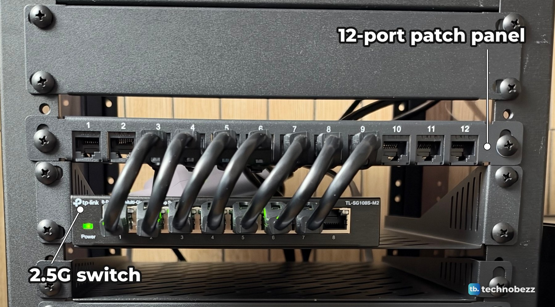 Seven short black jumpers looping from patch panel ports 3 to 9 down into ports 1 to 7 of a TP-Link 2.5G switch