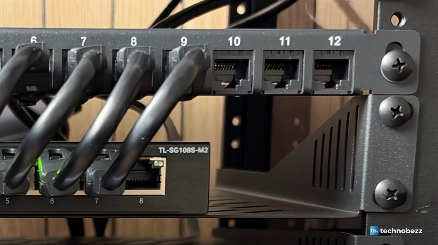 Close-up of empty patch panel ports 10, 11 and 12 beside a row of plugged-in jumpers