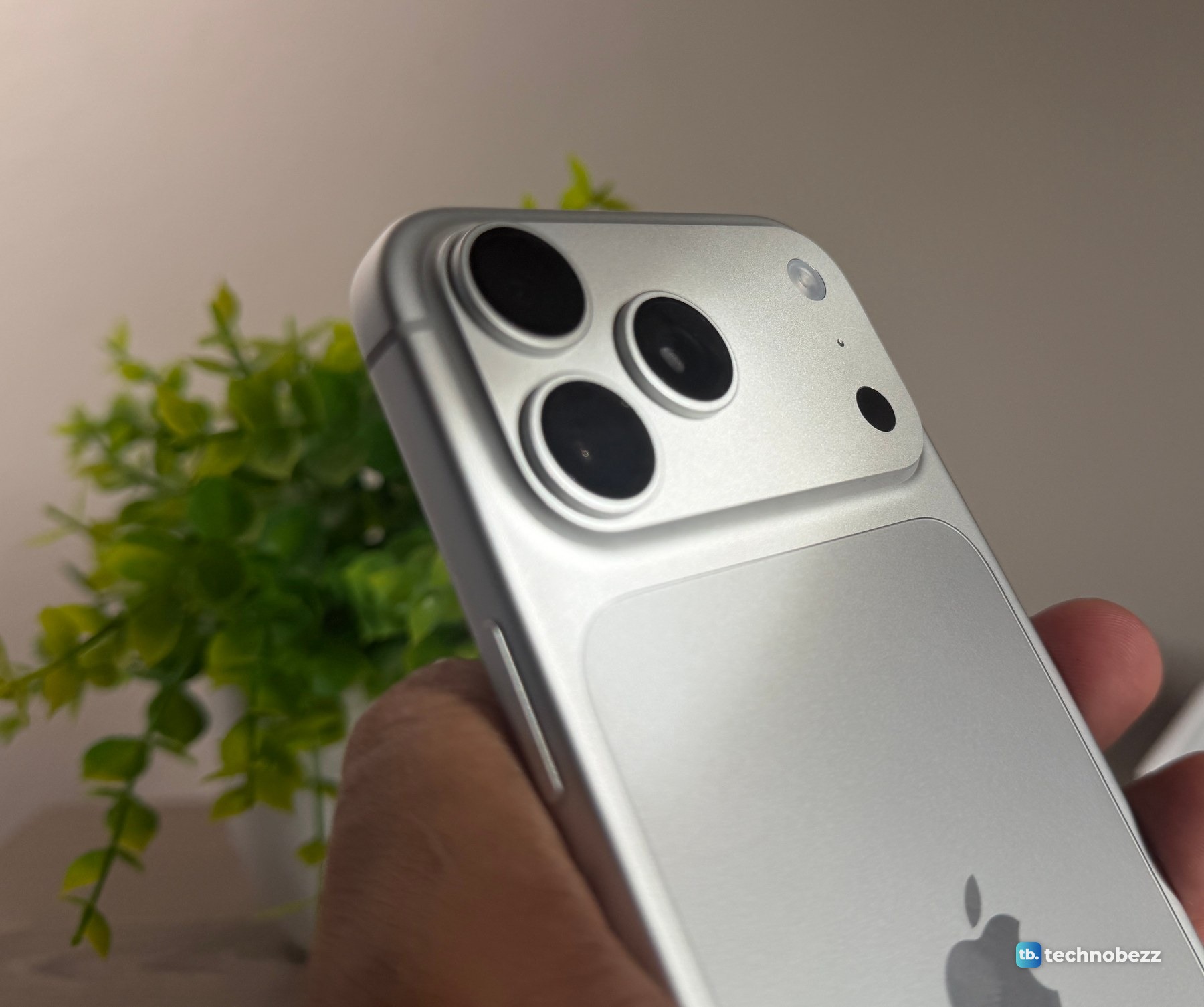 Close view of the three rear cameras on a Silver iPhone 18 Pro Max held in a hand