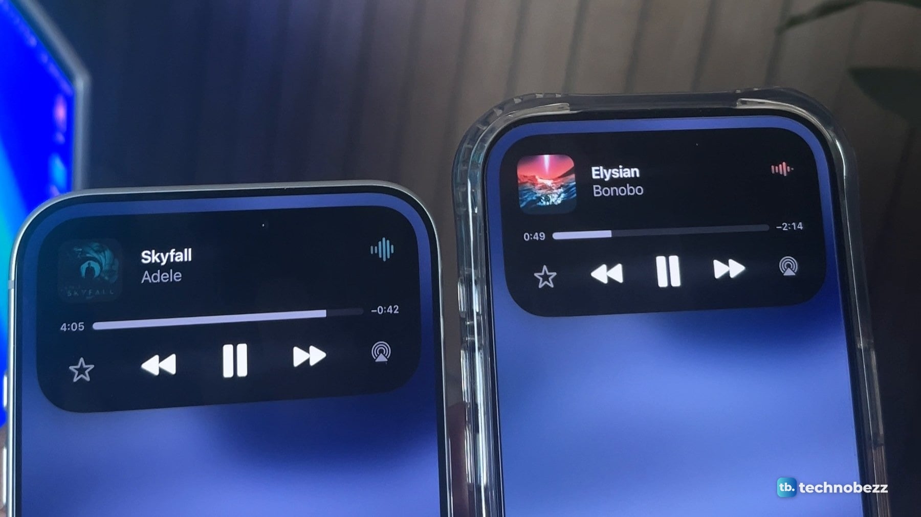 Two iPhones side by side with the Dynamic Island expanded into a music player that shows the track name, a progress bar and playback buttons