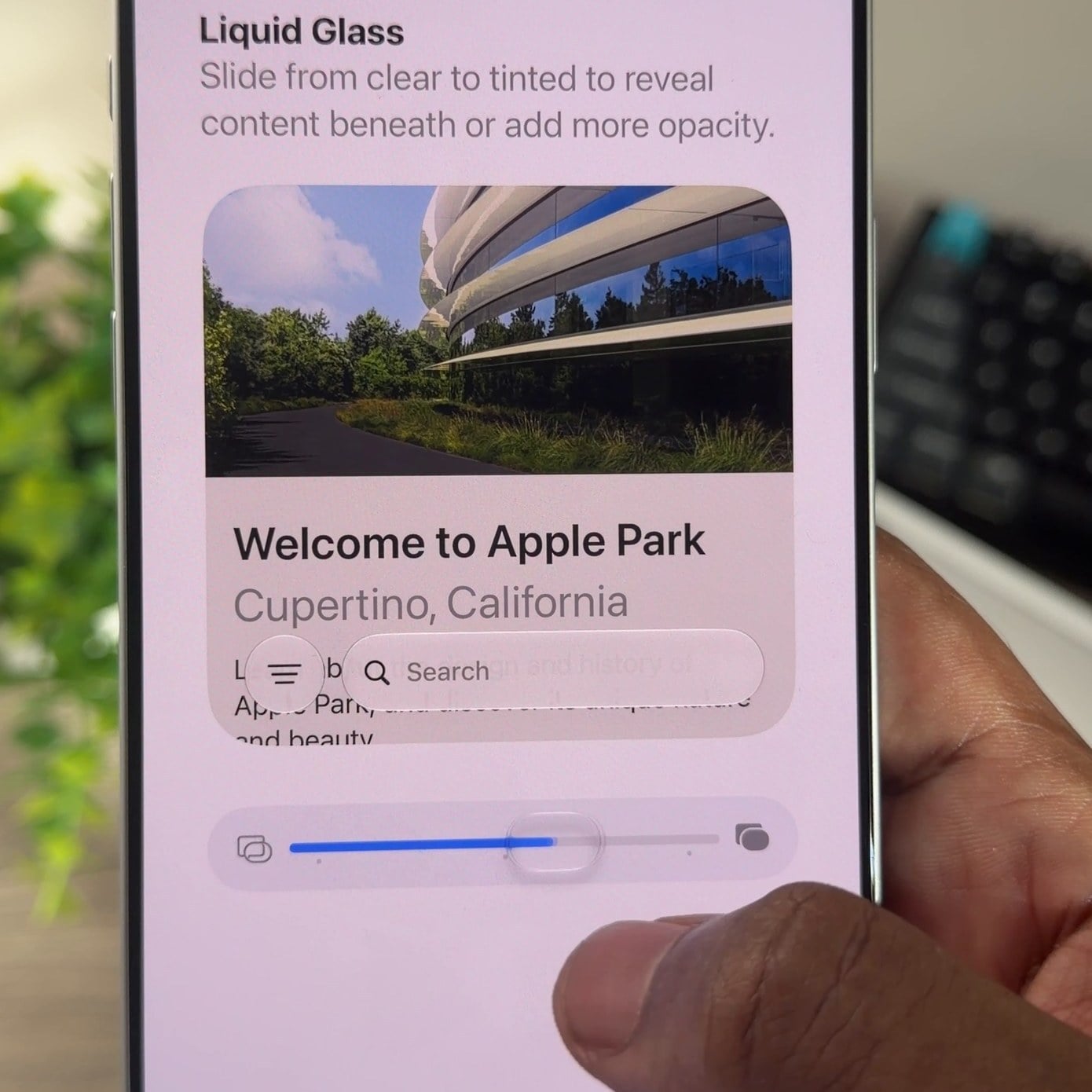 iPhone 18 Pro Max in hand showing the Liquid Glass screen with its clear to tinted slider