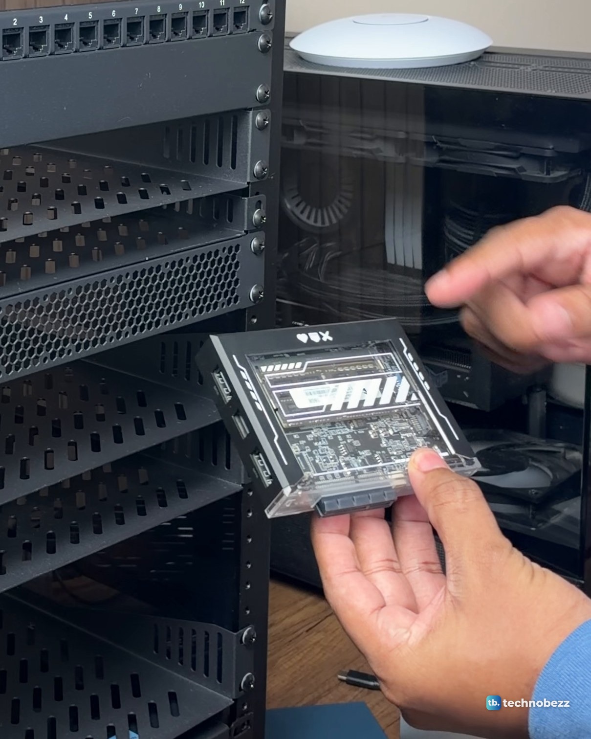 Hands holding the ZimaBlade 7700 in a clear case that shows the board inside