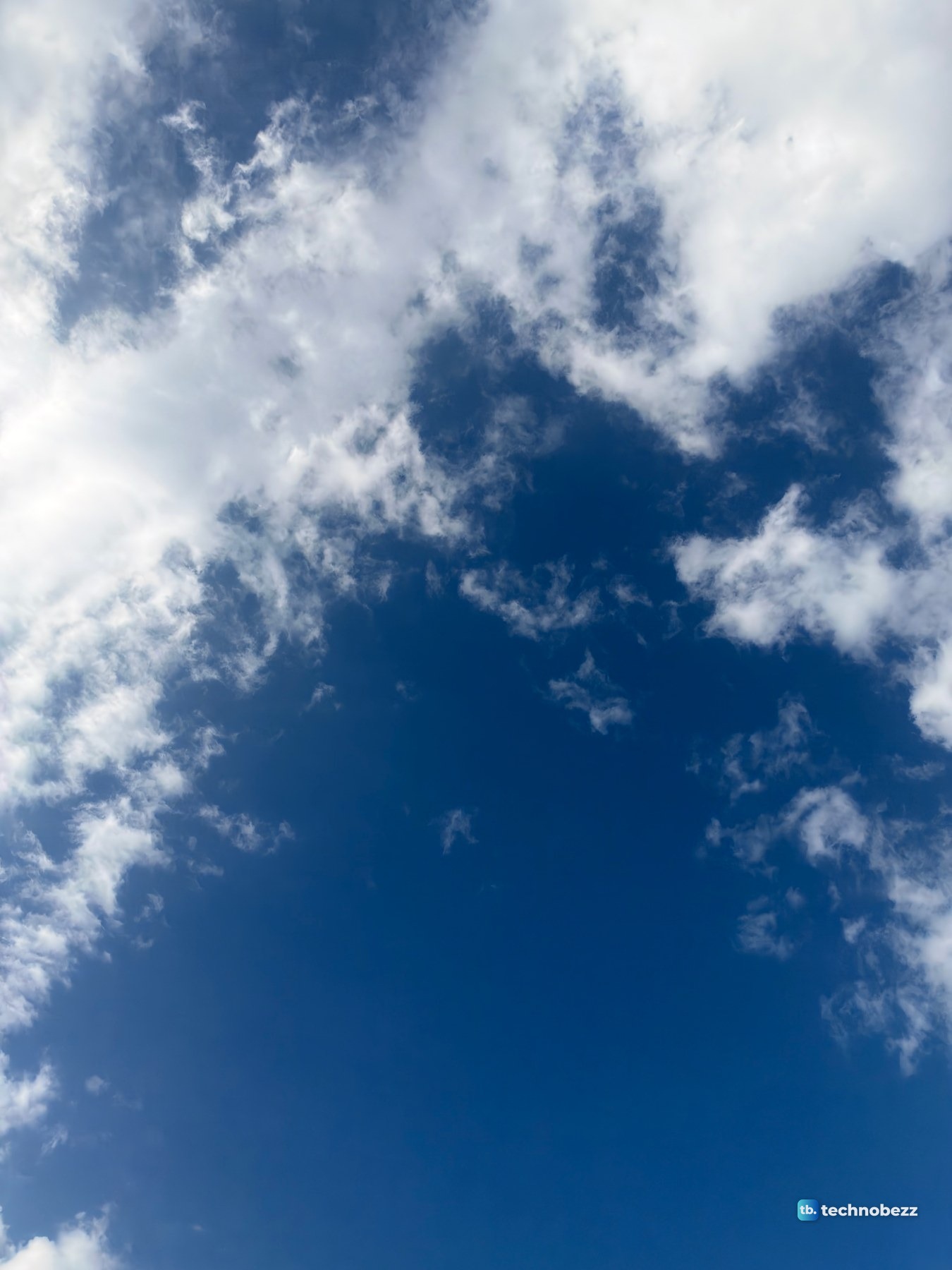 Deep blue sky with white clouds, photographed straight up