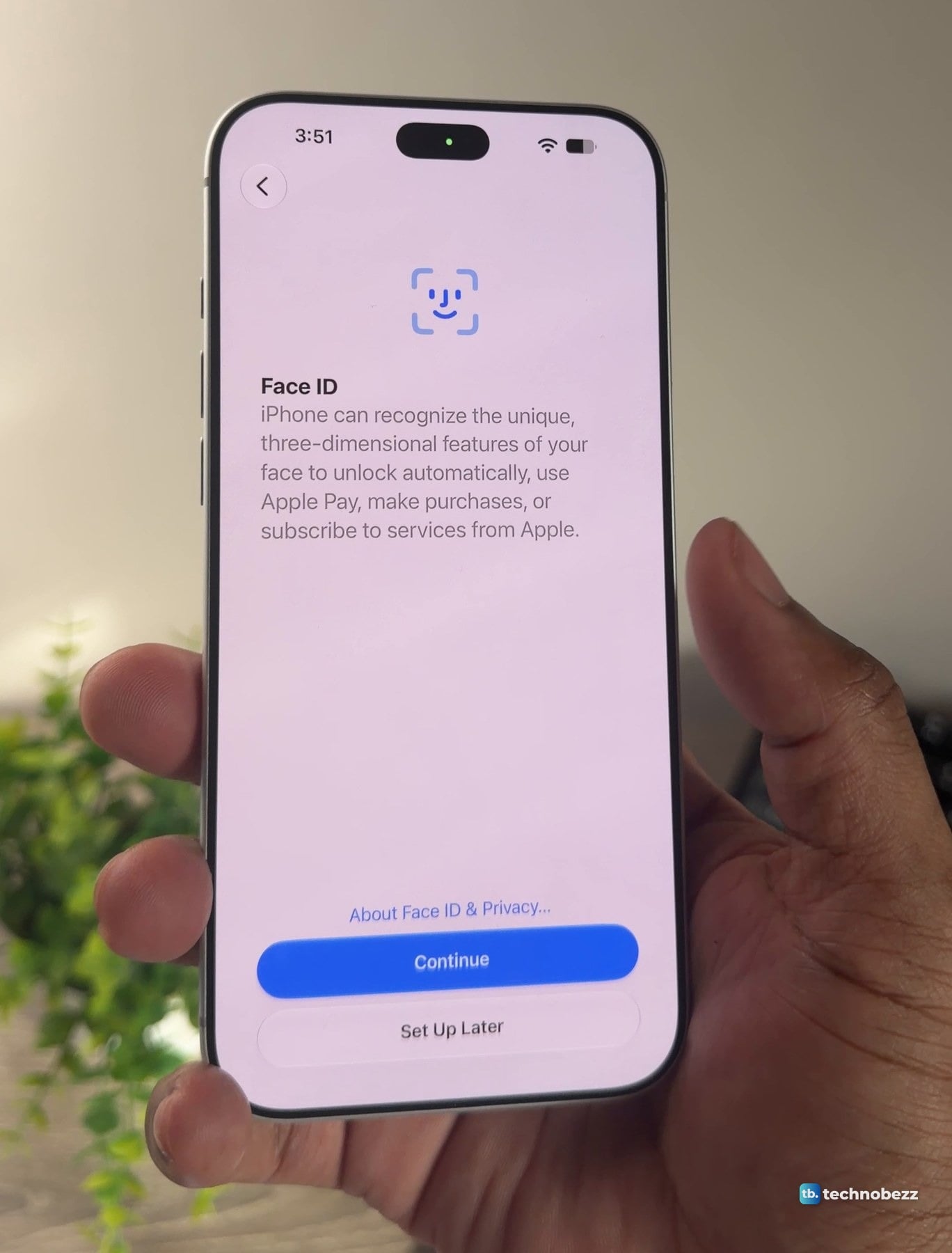 iPhone 18 Pro Max held in a hand showing the Face ID setup screen with Continue and Set Up Later buttons