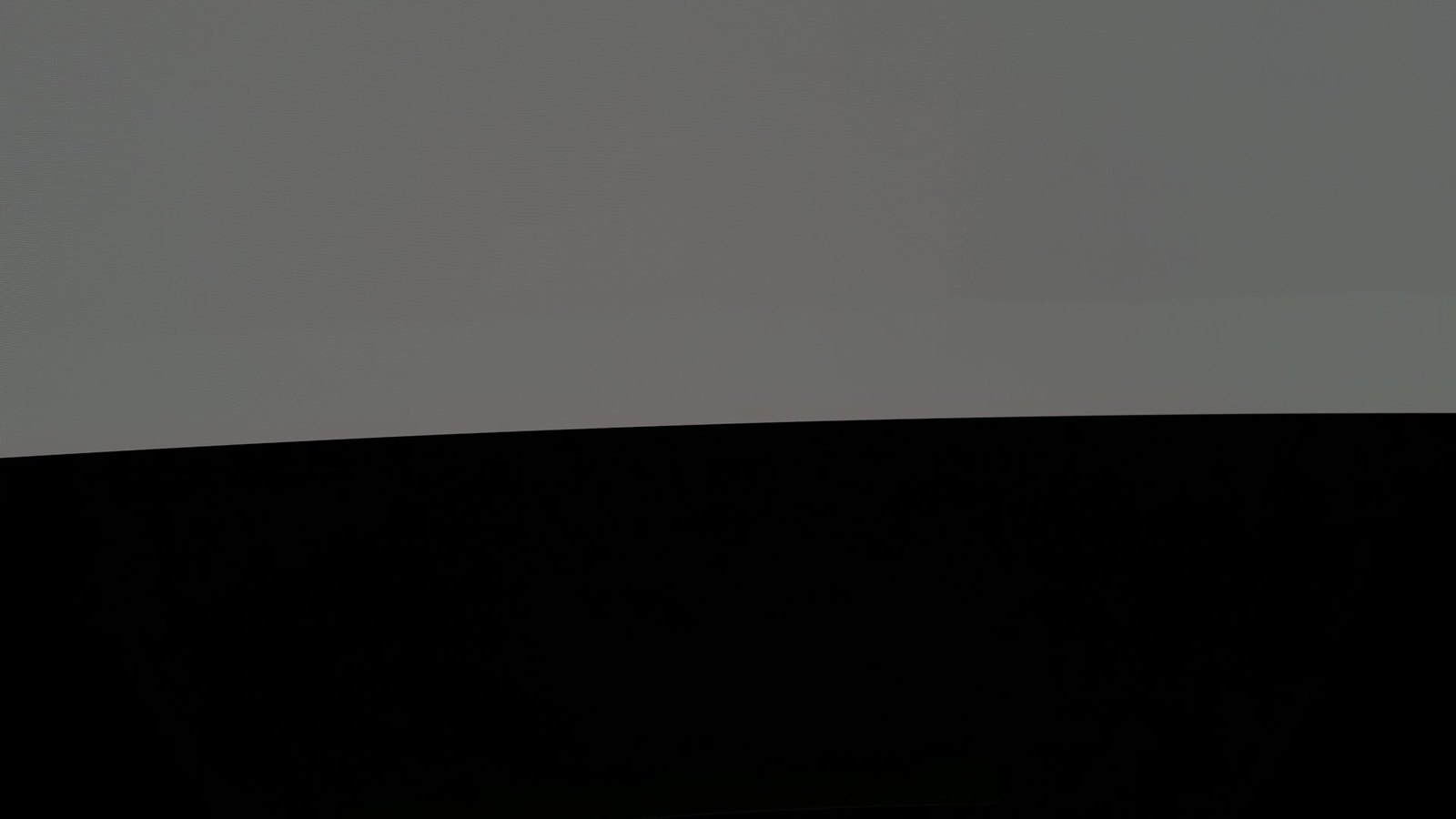 Close-up of the bottom edge of the Samsung Odyssey OLED G9 showing an even 20% gray test screen