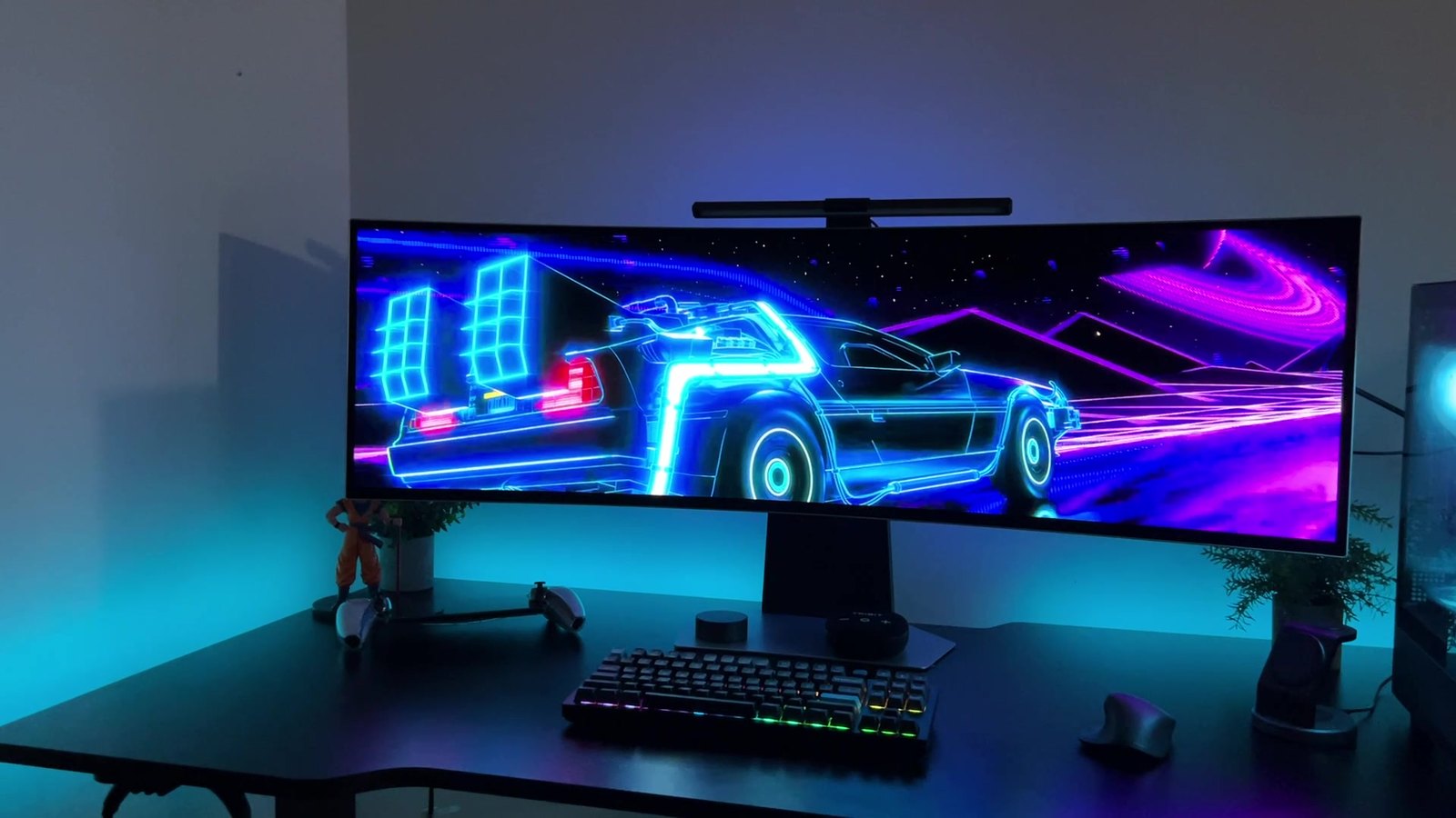 My Samsung Odyssey OLED G9 on a black desk with a neon wallpaper and blue desk lighting